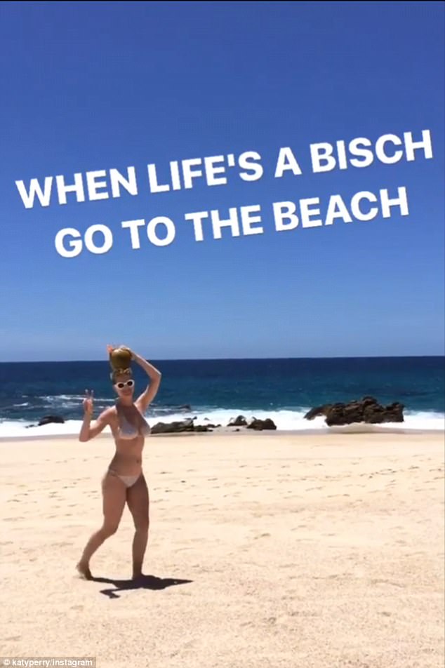 Life’s a beach! Katy Perry cavorts solo on the sand in a skimpy string Bikini with a coconut on her head