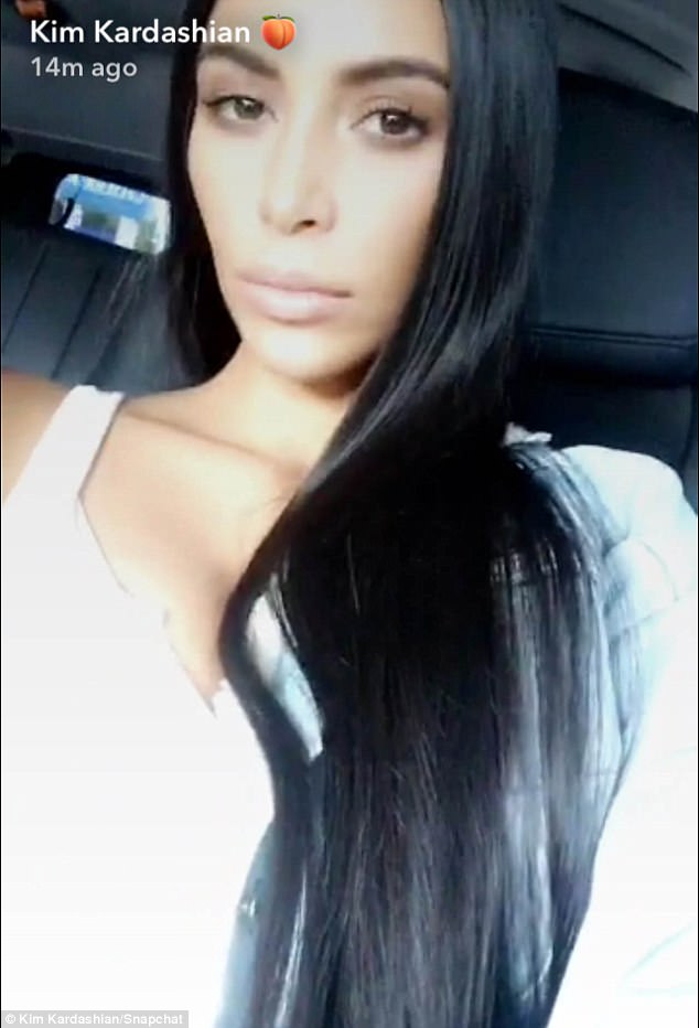 Wigging out! Kim Kardashian shows off new waist-length hair extensions in Snapchat video