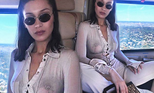 Bella Hadid flaunts bare chest in sheer Henley top while soaring above New York