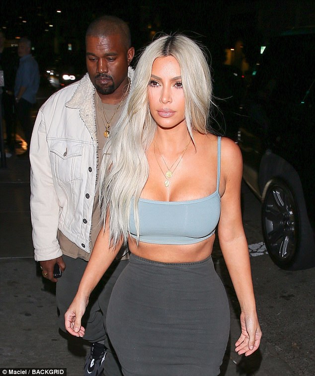 Kim Kardashian flaunts curves in crop top and skintight skirt as she heads to Kendall Jenner’s birthday bash with Kanye West