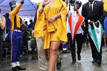 Rihanna turns heads in a bold yellow mini-dress as she attends renaming ceremony of the street she grew up on in Barbados