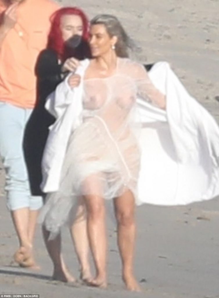 Making a splash! Kim Kardashian shows off a little too much in completely see-through dress for beach photoshoot in Malibu