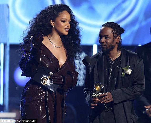 Braless Rihanna shows her edgy side as she wears trenchcoat to accept Grammy with Kendrick Lamar after skipping red carpet