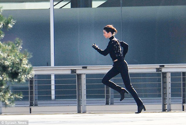 Kendall Jenner displays her natural athleticism as she sprints in three-inch heels and a stylish cropped jumper for latest fashion campaign in Paris