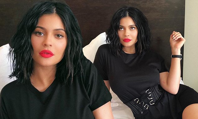 Kylie Jenner shows off sultry New Lip kit as she coquettishly poses across her bed in Black Dress