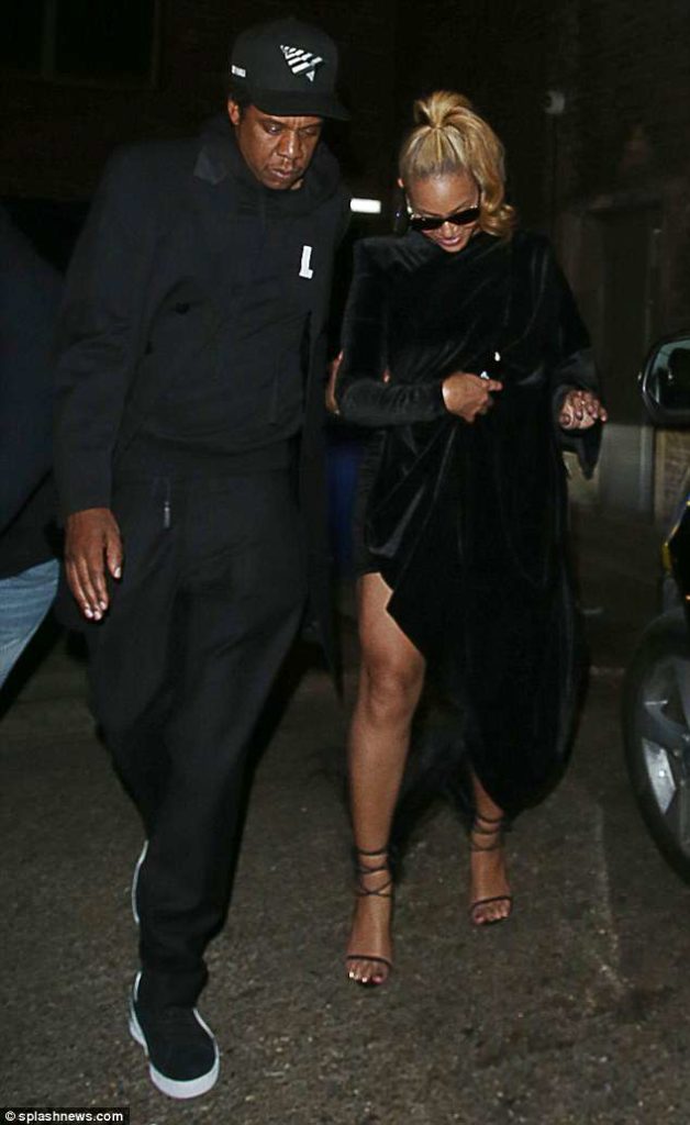 Beyonce showcases her toned legs in a black velvet mini-dress and feathered heels on a date night with Jay-Z in London