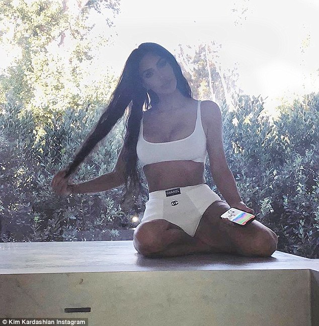 Kim Kardashian flaunts her ample cleavage in white designer Bikini