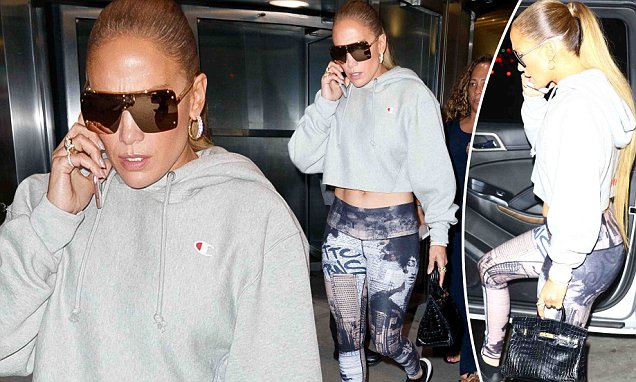 Jennifer Lopez flaunts her toned abs in patterned leggings and cropped sweater while out in NYC