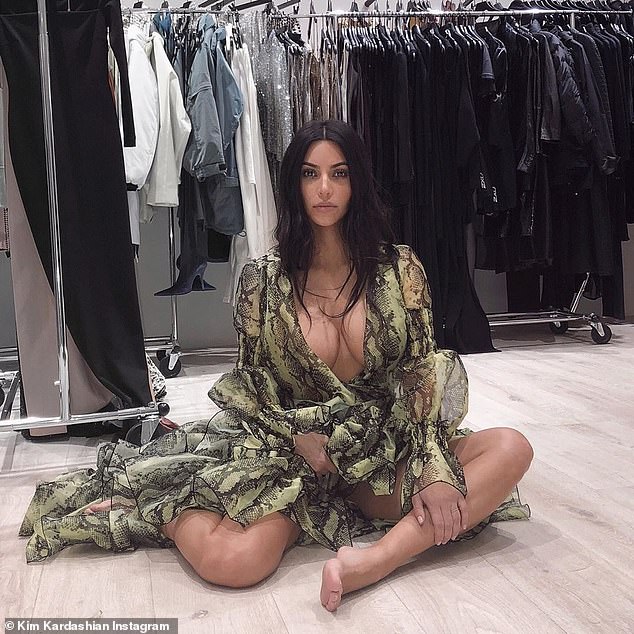 Kim Kardashian poses in the green snakeskin Print Dress